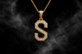 The Saintarini Diamond S Pendant — the house letterform set with brilliant-cut stones on a dark backdrop (placeholder image, to be replaced with the production photograph)