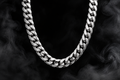 The Saintarini Cuban Chain in white gold — tightly interlocking links on a dark backdrop (placeholder image, to be replaced with the production photograph)